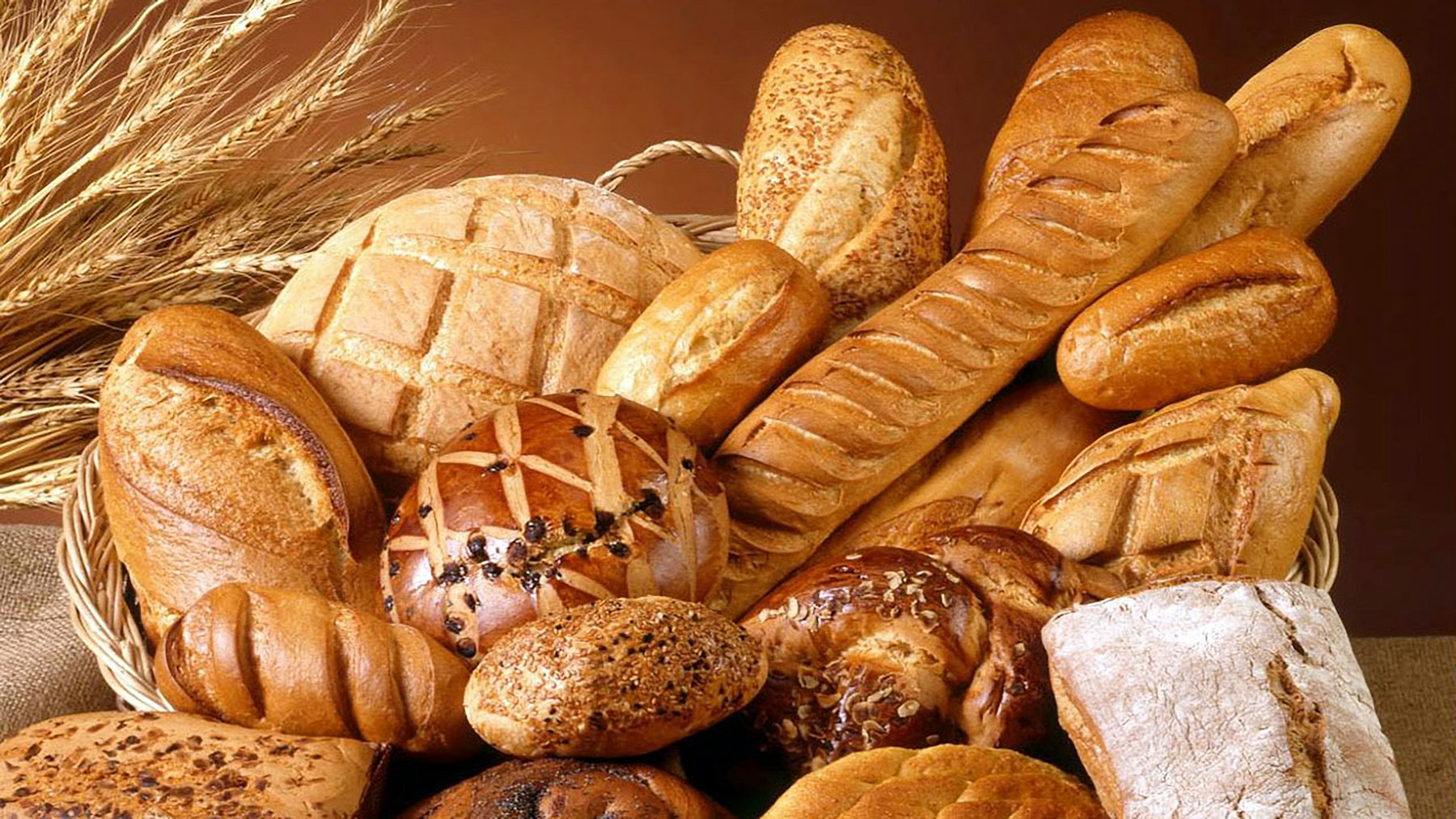 A basket of freshly baked breads and wheat